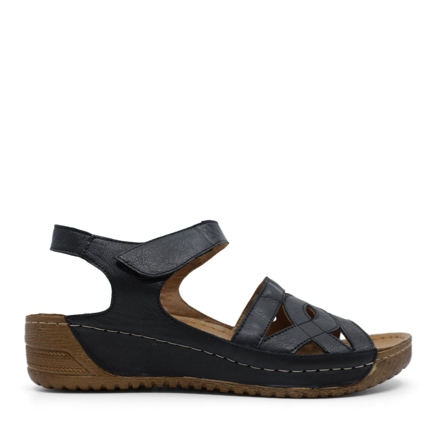 SIDE VIEW OF BLACK WEDGES WITH SMALL HEEL AND ADJUSTABLE VELCRO STRAP