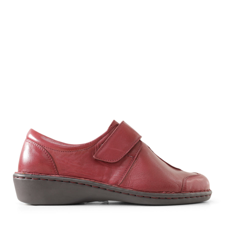 SIDE VIEW OF BLACK LEATHER CASUAL SHOE WITH VELCRO STRAP 