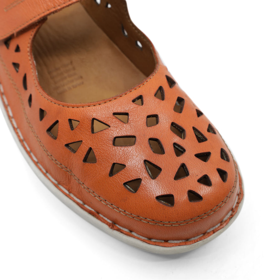 FRONT VIEW OF ORANGE LEATHER CASUAL SHOE WITH CUT OUTS ONT HE TOE WITH VELCRO STRAP AND WHITE SOLE
