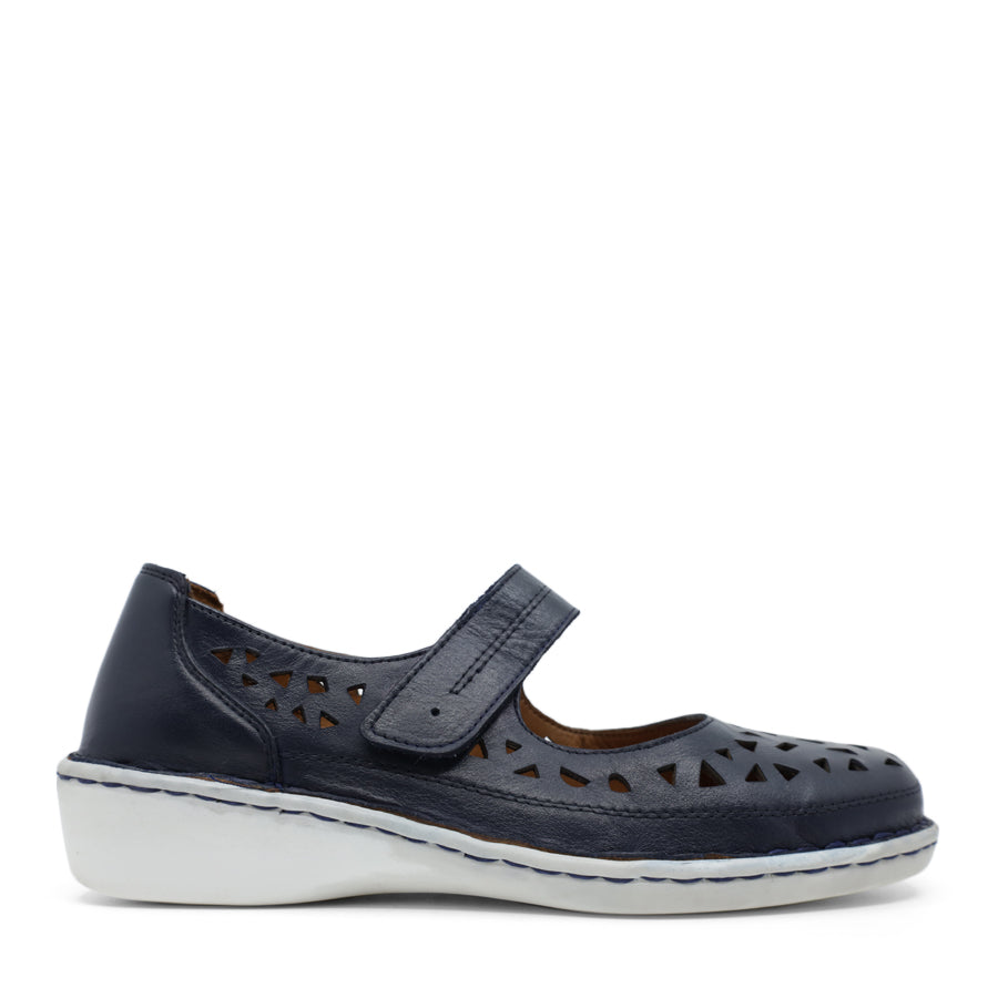 SIDE VIEW OF NAVY LEATHER CASUAL SHOE WITH VELCRO STRAP AND WHITE SOLE