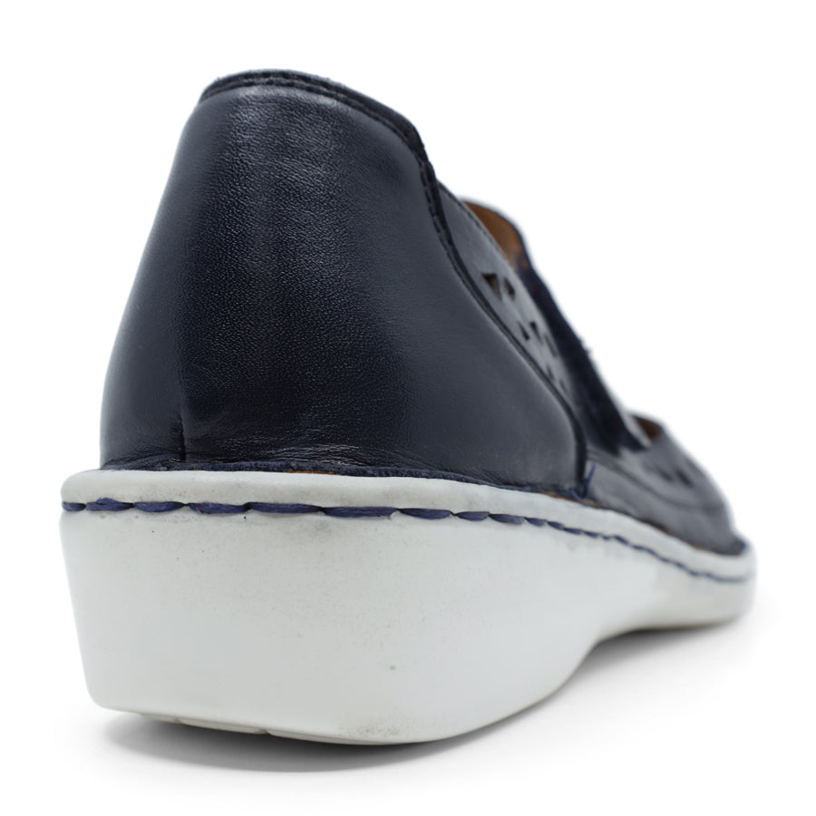 BACK VIEW OF NAVY LEATHER CASUAL SHOE WITH VELCRO STRAP AND WHITE SOLE