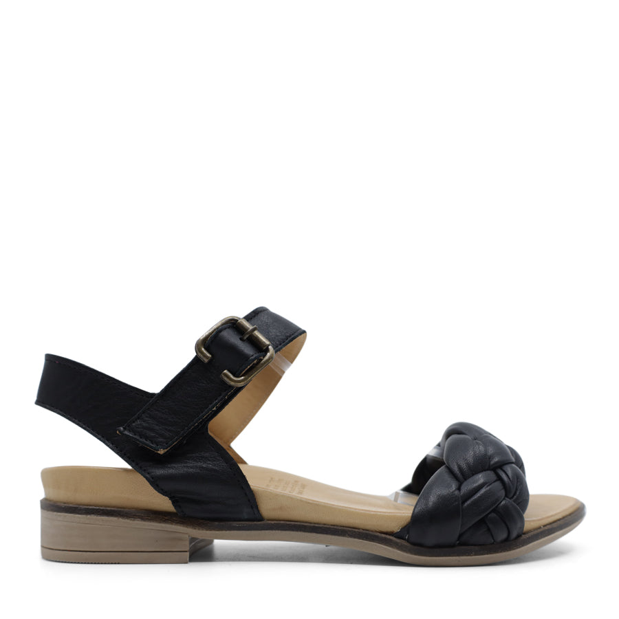 SIDE VIEW OF BLACK LEATHER STRAP SANDAL. FRONT STRAP INTERWOVEN PLAITED LEATHER. VELCRO ADJUSTABLE Y BACK WITH DECORATIVE BUCKLE