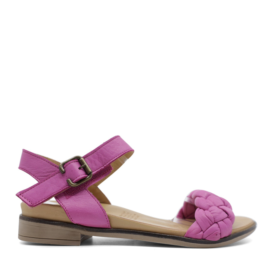  SIDE VIEW OF PINK LEATHER STRAP SANDAL. FRONT STRAP INTERWOVEN PLAITED LEATHER. VELCRO ADJUSTABLE Y BACK WITH DECORATIVE BUCKLE