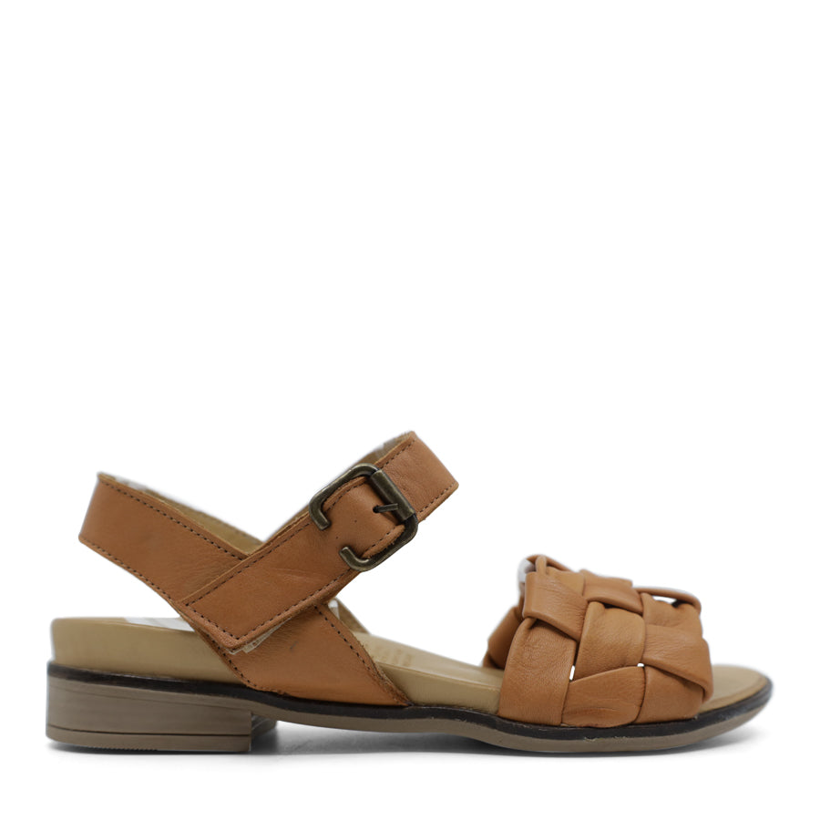 SIDE VIEW OF TAN LEATHER STRAP SANDAL. FRONT STRAP INTERWOVEN PLAITED LEATHER. VELCRO ADJUSTABLE Y BACK WITH DECORATIVE BUCKLE