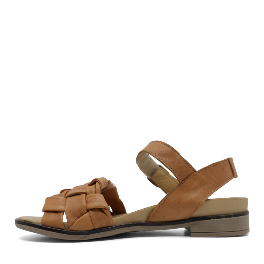 SIDE VIEW OF TAN LEATHER STRAP SANDAL. FRONT STRAP INTERWOVEN PLAITED LEATHER. VELCRO ADJUSTABLE Y BACK WITH DECORATIVE BUCKLE