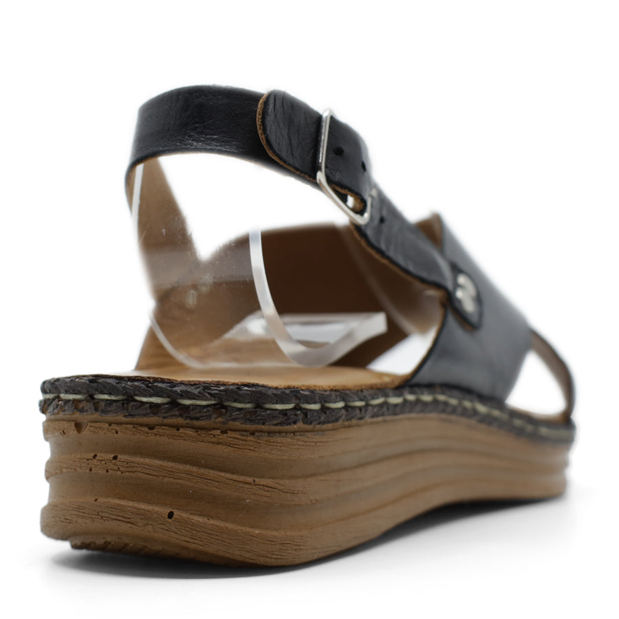 BACK VIEW OF BLACK LEATHER CRISS CROSS FRONT SANDAL WITH ADJUSTABLE BUCKLE AND CUSHIONED SOLE