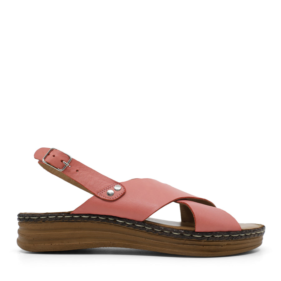 SIDE VIEW OF TAN LEATHER CRISS CROSS FRONT SANDAL WITH ADJUSTABLE BUCKLE AND CUSHIONED SOLE