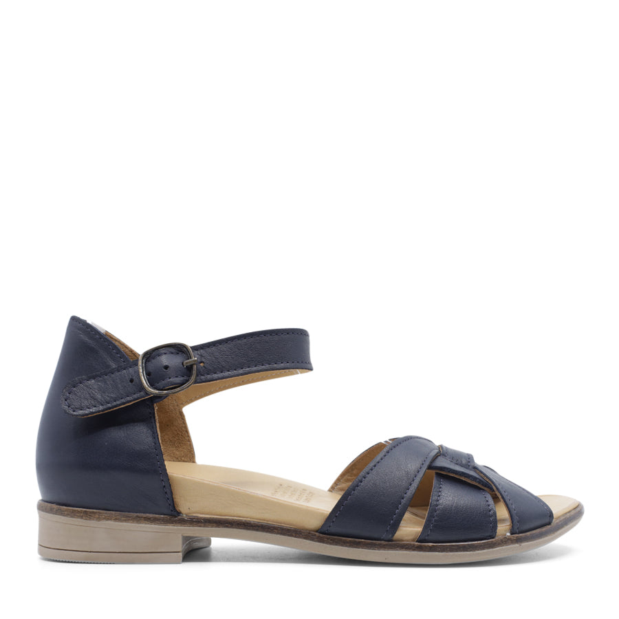  SIDE VIEW OF NAVY LEATHER SANDAL WITH INTERWOVEN POCKED BACK FRONT AND ADJUSTABLE BUCKLE