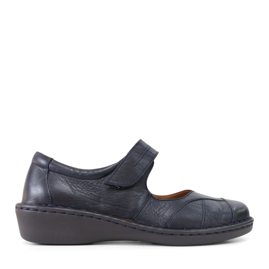 SIDE VIEW OF BLUE LEATHER FLAT CASUAL SHOW WITH VELCRO CLOSURE