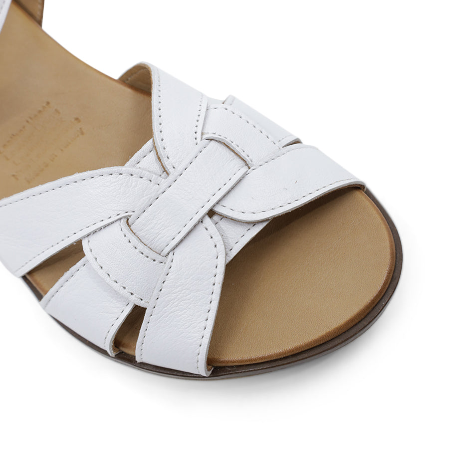 SIDE VIEW OF WHITE LEATHER SANDAL WITH INTERWOVEN FRONT STRAP