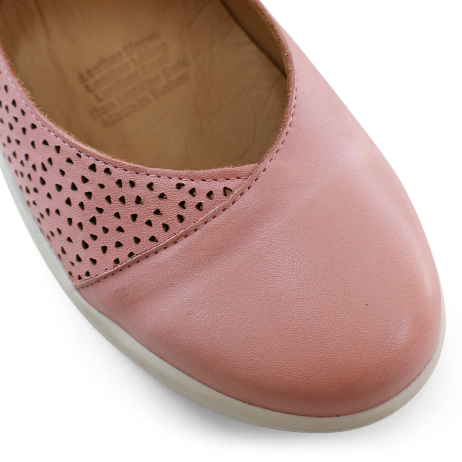 FRONT VIEW OF PINK CASUAL SHOE WITH VELCRO STRAP AND SPECKLE CUT OUT DETAILING ON THE SIDES 