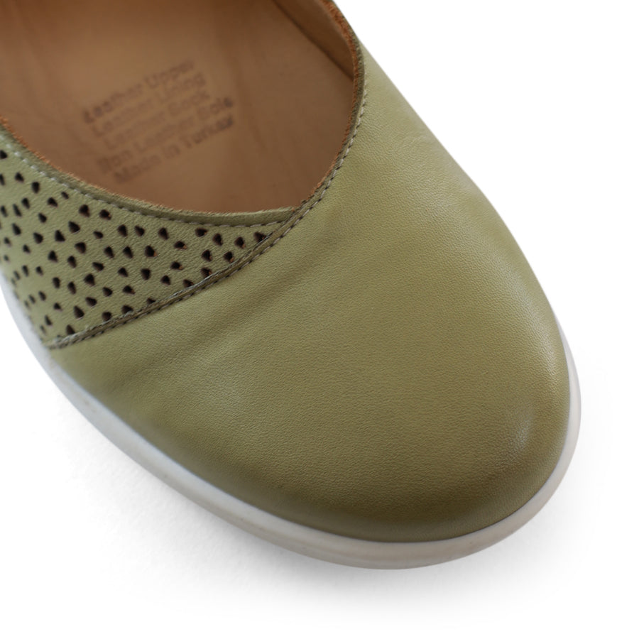 SIDE VIEW OF GREEN CASUAL SHOE WITH VELCRO STRAP AND SPECKLE CUT OUT DETAILING ON THE SIDES 