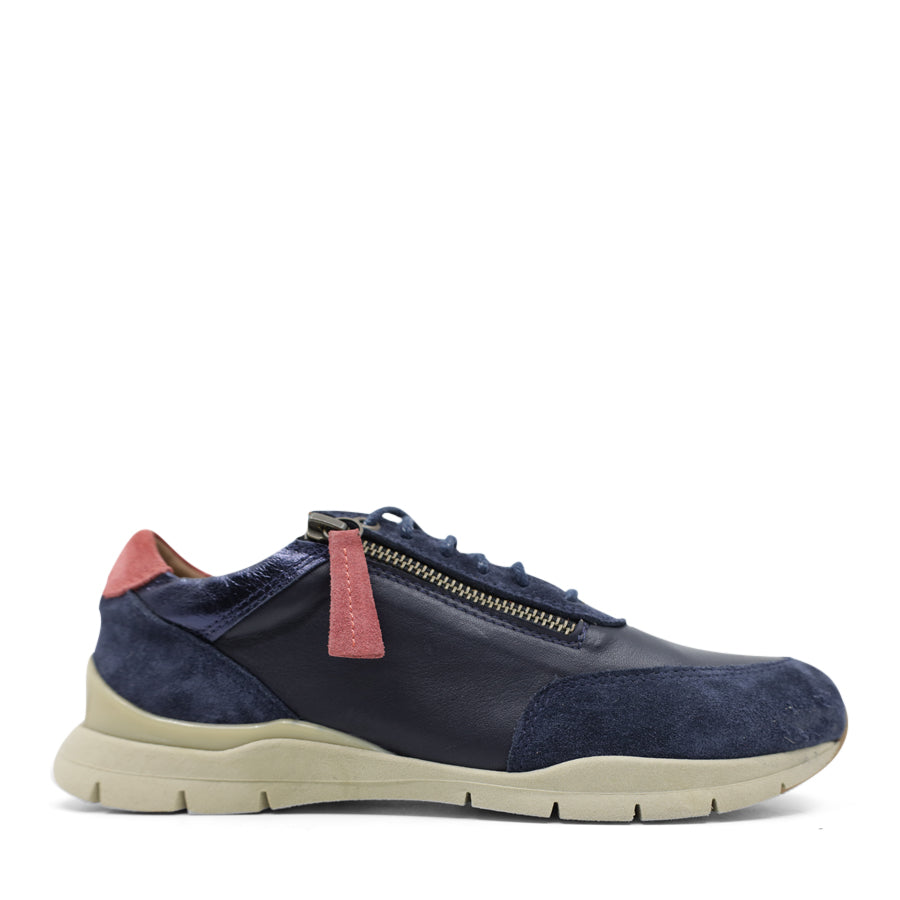 SIDE VIEW OF NAVY CASUAL SHOE WITH RED ZIPPER TAG AND PATCH ON BACK OF HEEL 