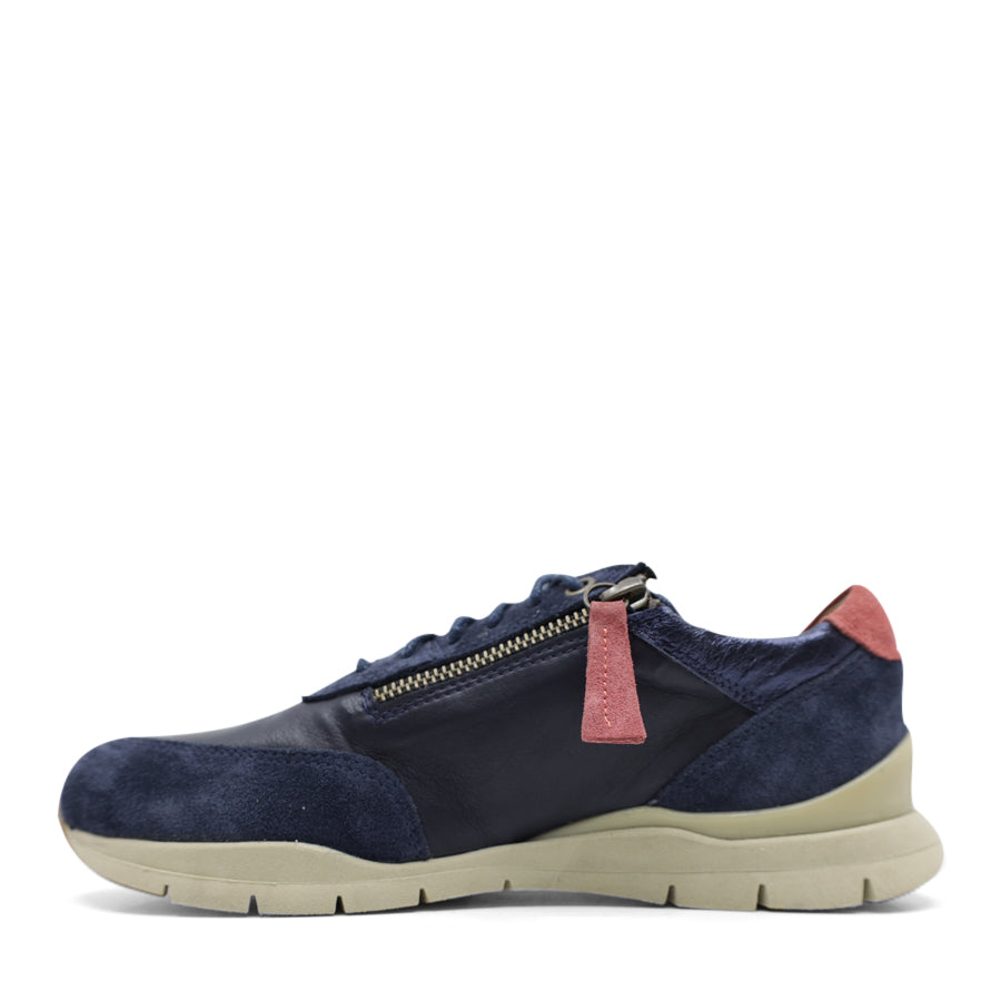 SIDE VIEW OF NAVY CASUAL SHOE WITH RED ZIPPER TAG AND PATCH ON BACK OF HEEL 