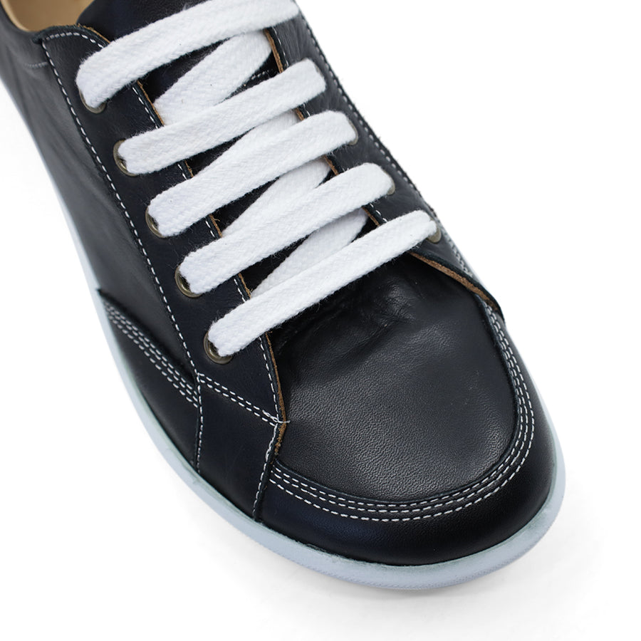 FRONT VIEW OF BLACK LACE UP SNEAKER WITH WHITE STITCHING AND SOLE 