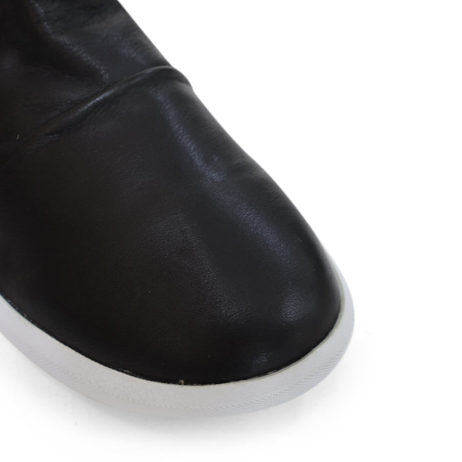 FRONT VIEW OF BLACK ANKLE BOOT WITH SIDE ZIP AND WHITE SOLE