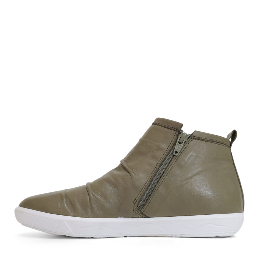 SIDE VIEW OF GREEN ANKLE BOOT WITH SIDE ZIP AND WHITE SOLE