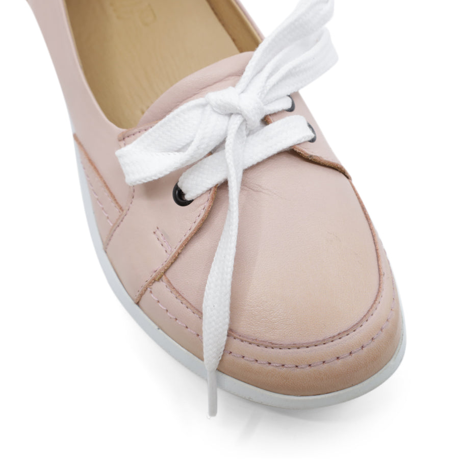 FRONT VIEW OF PINK CASUAL SHOE WITH LACES AT THE FRONT AND WHITE SOLE 