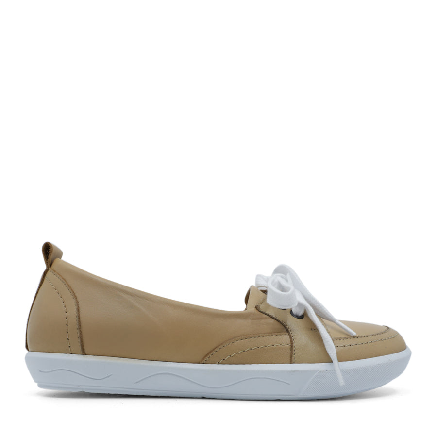 SIDE VIEW OF BEIGE CASUAL SHOE WITH LACES AT THE FRONT AND WHITE SOLE 
