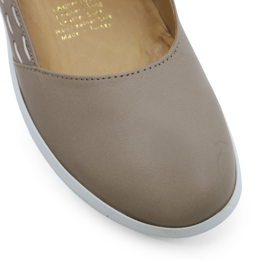 FRONT VIEW OF GREY CASUAL SHOE WITH STRAP, WHITE STITCH DETAIL AND WHITE SOLE 