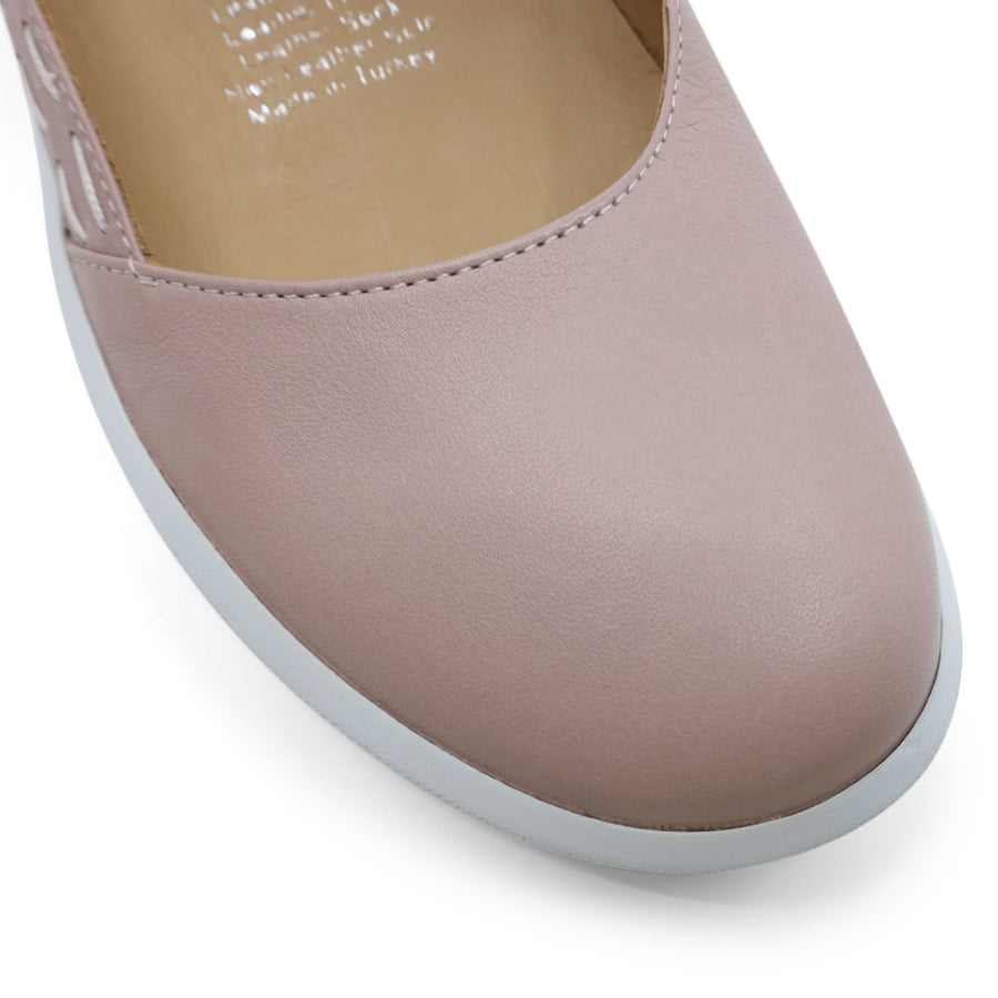 FRONT VIEW OF PINK CASUAL SHOE WITH STRAP, WHITE STITCH DETAIL AND WHITE SOLE 