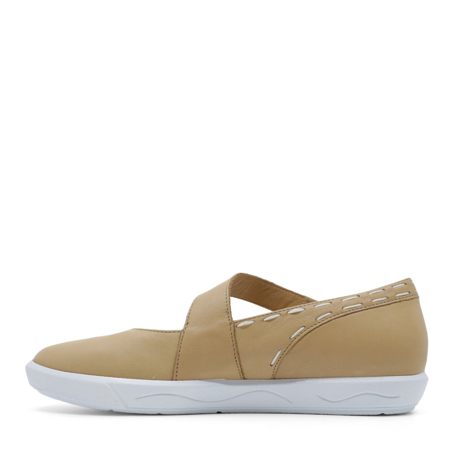 SIDE VIEW OF BEIGE CASUAL SHOE WITH STRAP, WHITE STITCH DETAIL AND WHITE SOLE 