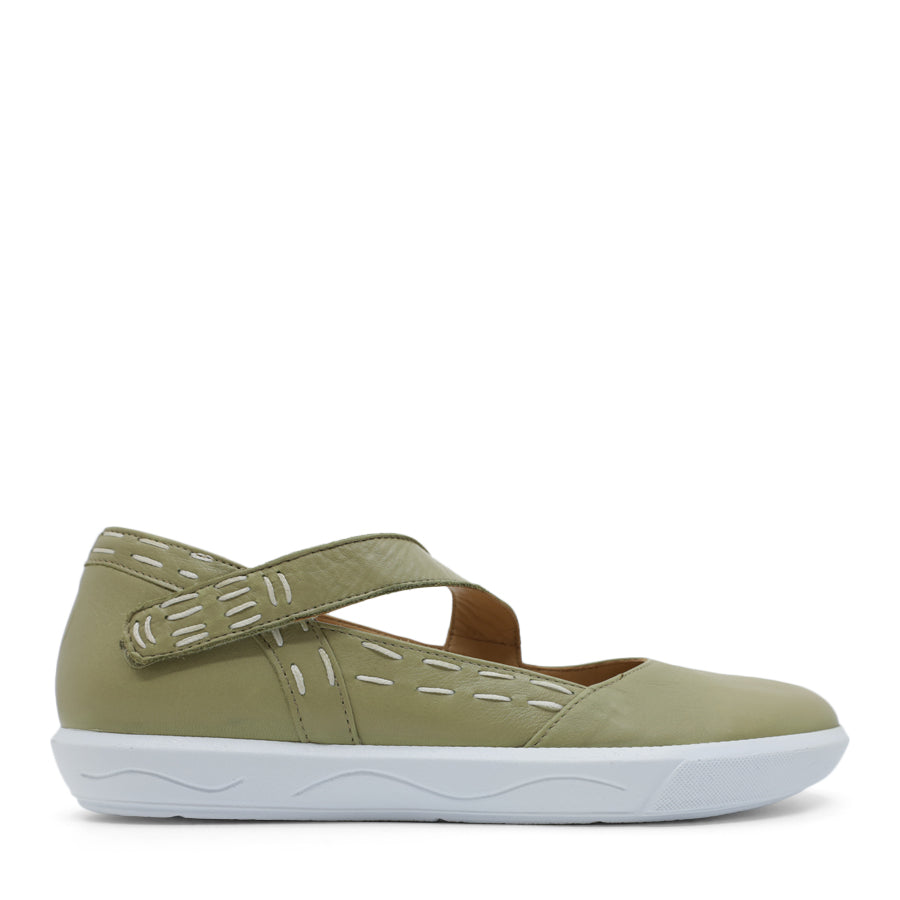 SIDE VIEW OF GREEN CASUAL SHOE WITH STRAP, WHITE STITCH DETAIL AND WHITE SOLE