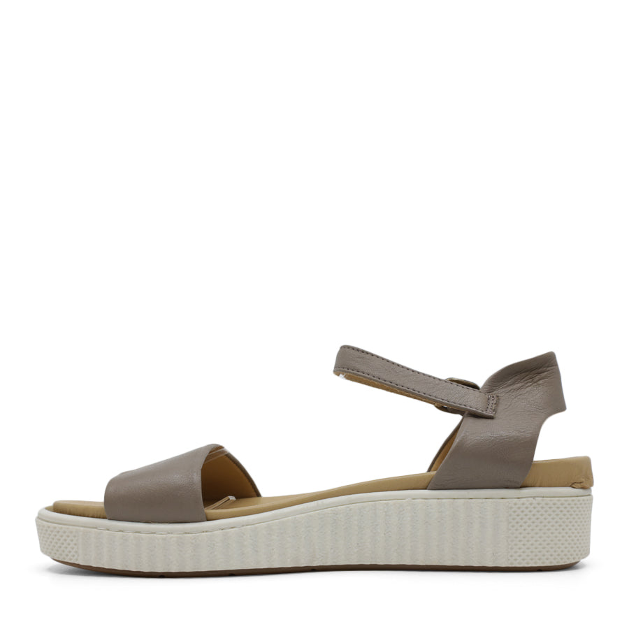 SIDE VIEW OF GREY SANDAL WITH BUCKLE AND WHITE SOLE 