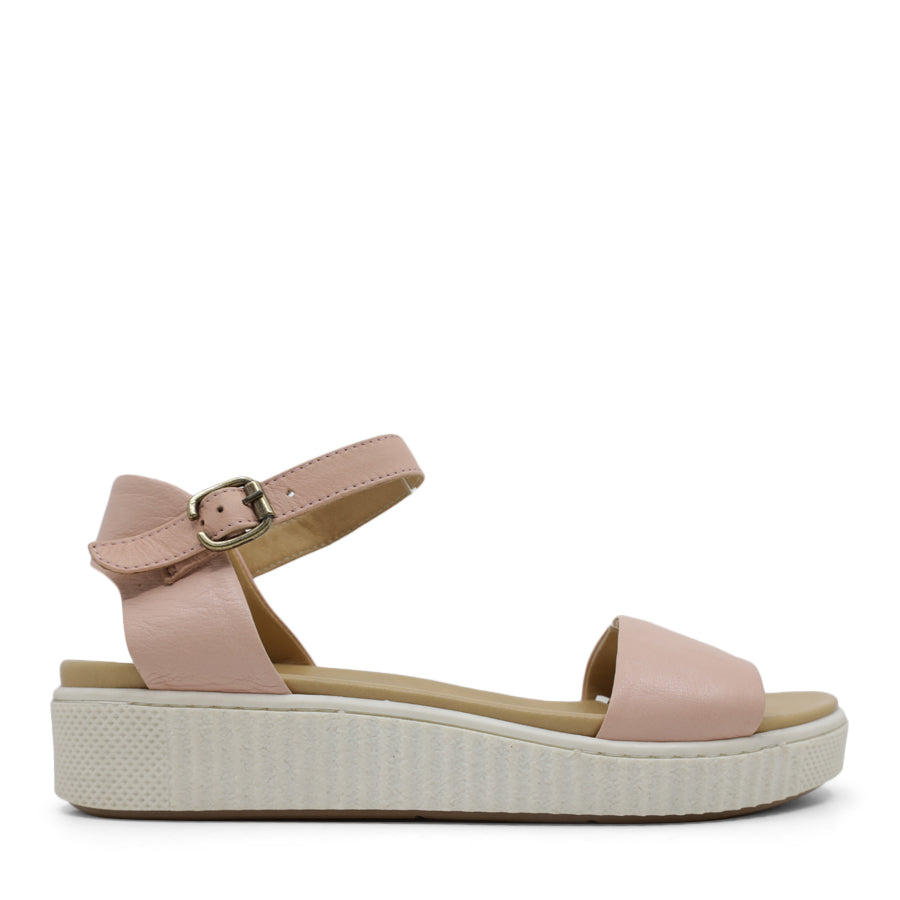 SIDE VIEW OF PINK SANDAL WITH BUCKLE AND WHITE SOLE