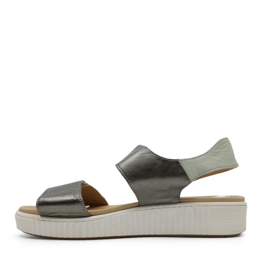 SIDE VIEW OF METALLIC GREEN SANDAL WITH TWO VELCRO STRAPS AND WHITE SOLE  