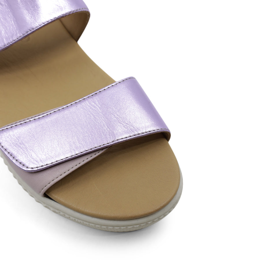FRONT VIEW OF METALLIC PINK SANDAL WITH TWO VELCRO STRAPS AND WHITE SOLE 