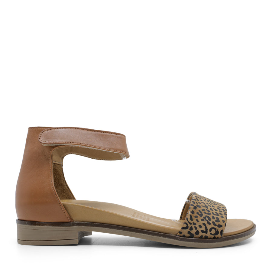 SIDE VIEW OF BEIGE LEATHER SANDAL WITH LEOPARD PRINT DETAIL ON FRONT AND VELCRO STRAP TO SECURE 