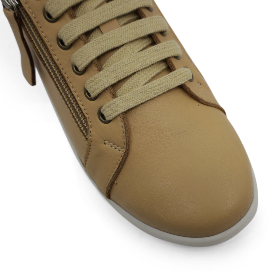 FRONT VIEW OF TAN LACE UP SNEAKER WITH SIDE ZIP AND WHITE SOLE 