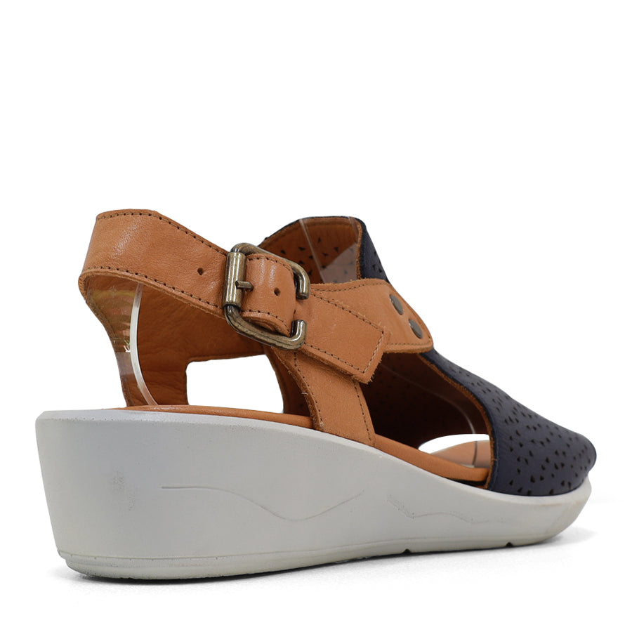 BACK VIEW OF NAVY AND TAN Y BACK SANDAL WITH WHITE SOLE AND ADJUSTABLE BUCKLE 
