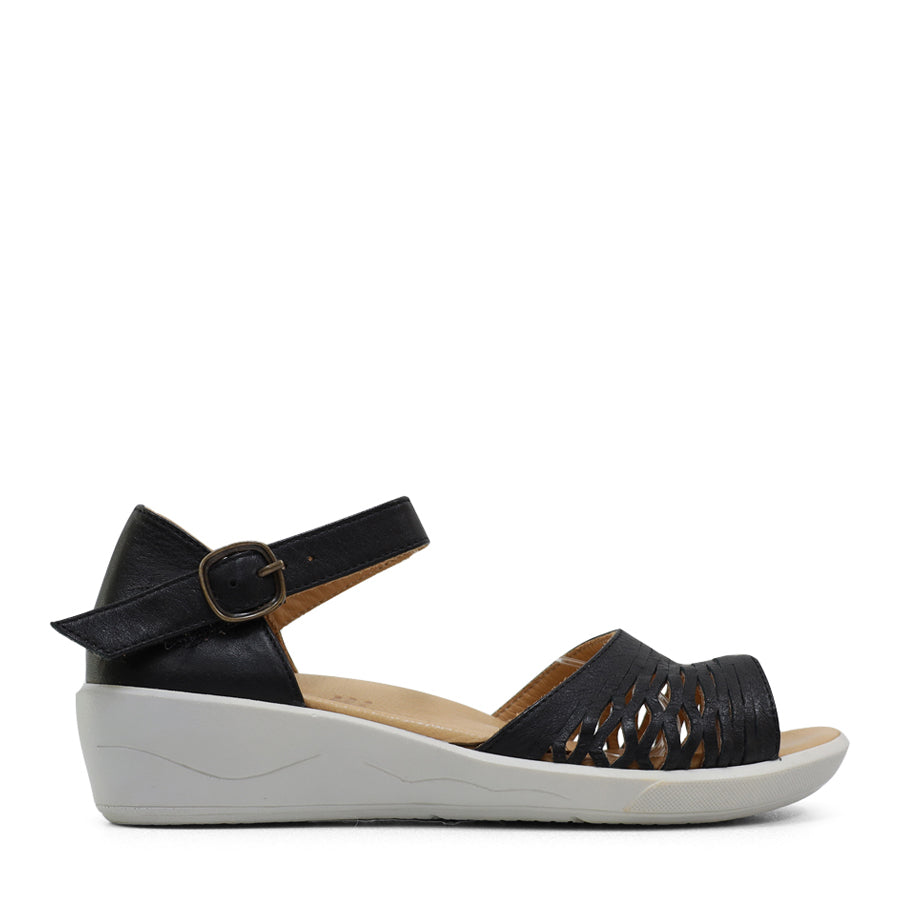 SIDE VIEW OF YELLOW SANDAL WITH WHITE SOLE AND ADJUSTABLE BUCKLE 