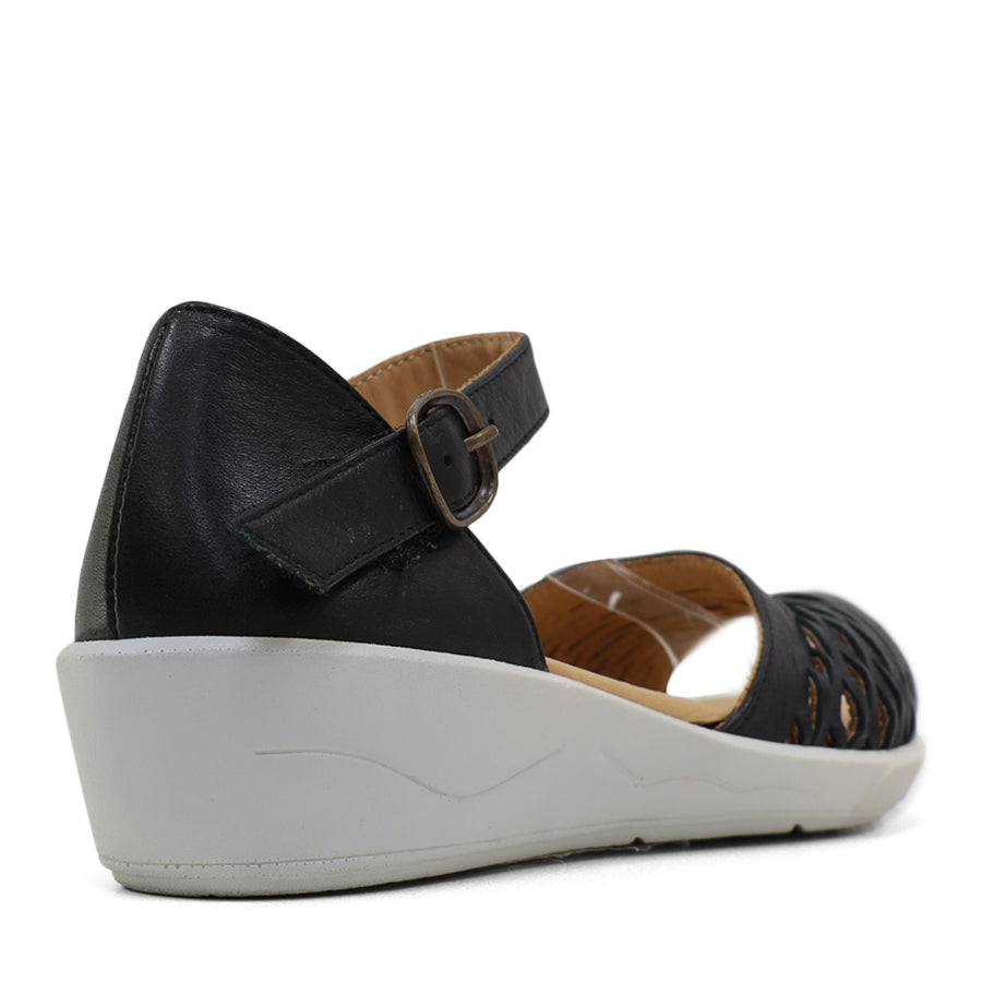 BACK VIEW OF BLACK SANDAL WITH WHITE SOLE AND ADJUSTABLE BUCKLE 