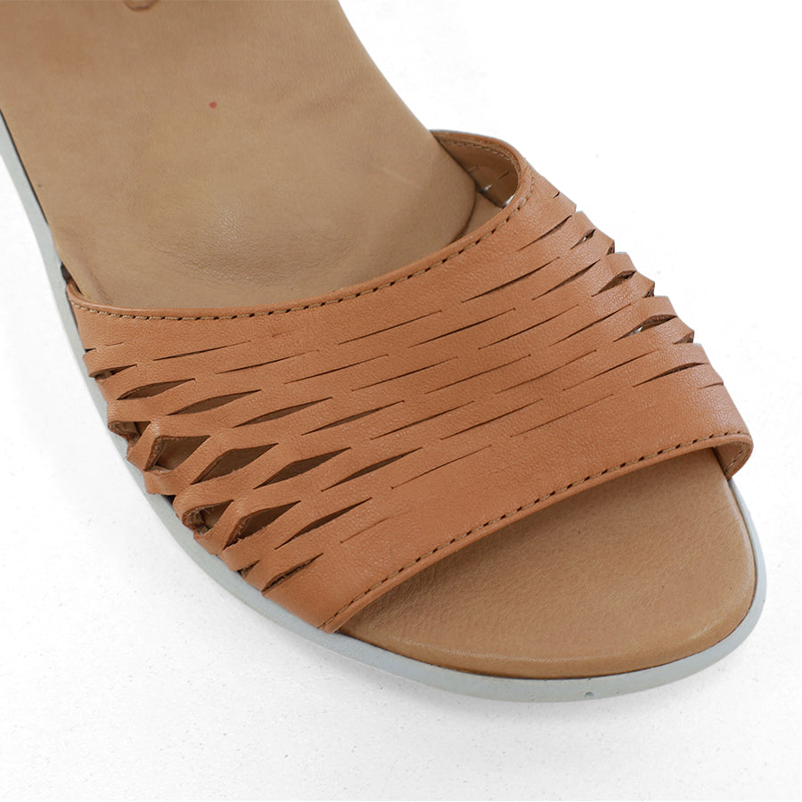 FRONT VIEW OF TAN SANDAL WITH WHITE SOLE AND ADJUSTABLE BUCKLE 