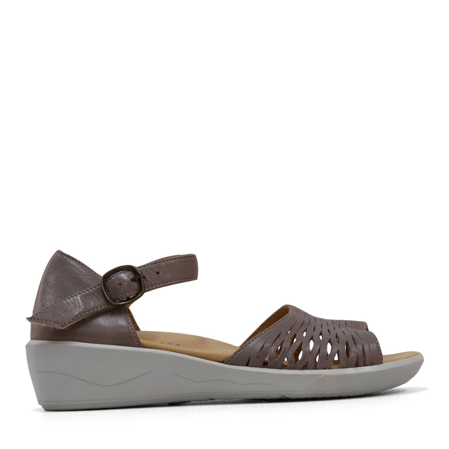 SIDE VIEW OF YELLOW SANDAL WITH WHITE SOLE AND ADJUSTABLE BUCKLE 