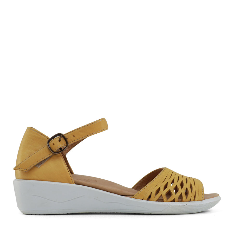 SIDE VIEW OF YELLOW SANDAL WITH WHITE SOLE AND ADJUSTABLE BUCKLE 