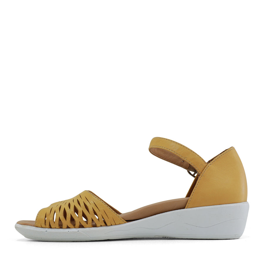 SIDE VIEW OF YELLOW SANDAL WITH WHITE SOLE AND ADJUSTABLE BUCKLE 