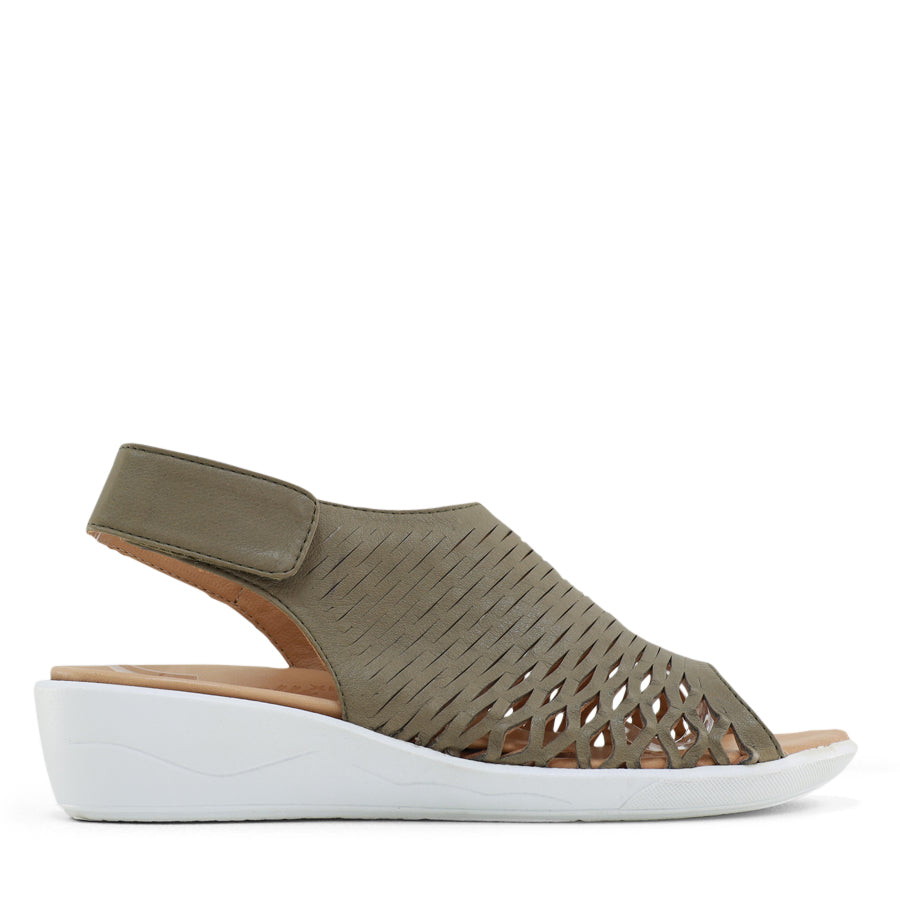 SIDE VIEW OF BLACK OPEN TOE SANDAL WITH WHITE SOLE AND VELCRO STRAP AROUND THE HEEL 