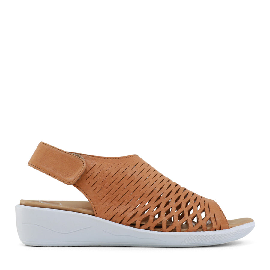 SIDE VIEW OF TAN OPEN TOE SANDAL WITH WHITE SOLE AND VELCRO STRAP AROUND THE HEEL 