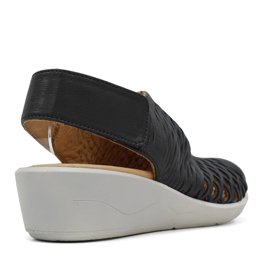 BACK VIEW OF BLACK OPEN TOE SANDAL WITH WHITE SOLE AND VELCRO STRAP AROUND THE HEEL 