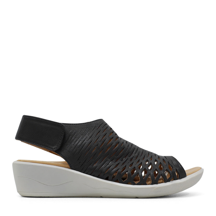 SIDE VIEW OF BLACK OPEN TOE SANDAL WITH WHITE SOLE AND VELCRO STRAP AROUND THE HEEL 