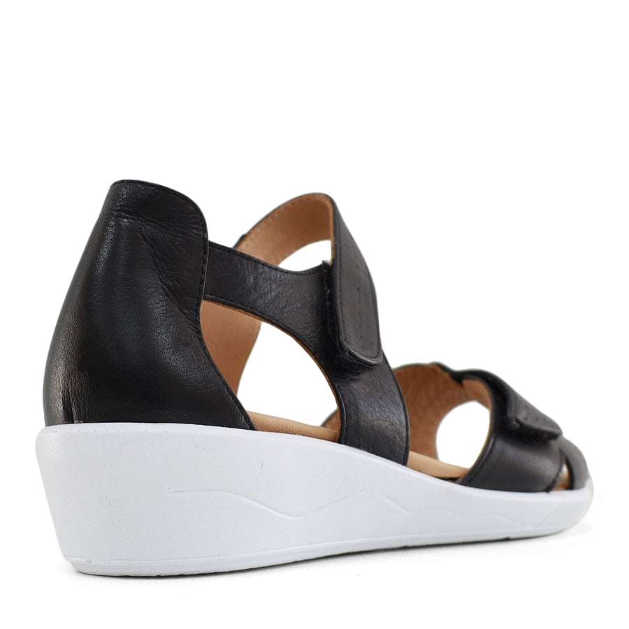 BACK VIEW OF BLACK OPEN TOE SANDAL WITH TWO VELCRO STRAPS AND WHITE SOLE