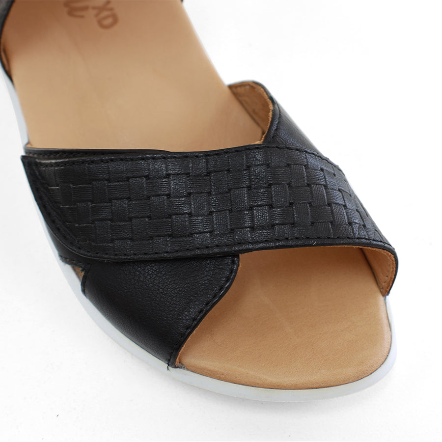 FRONT VIEW OF BLACK OPEN TOE SANDAL WITH TWO VELCRO STRAPS AND WHITE SOLE
