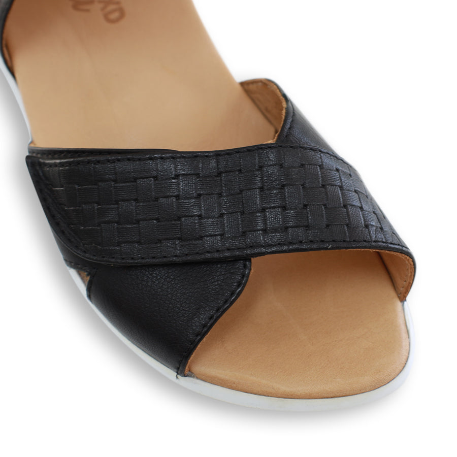 FRONT VIEW OF BLACK OPEN TOE SANDAL WITH TWO VELCRO STRAPS AND WHITE SOLE