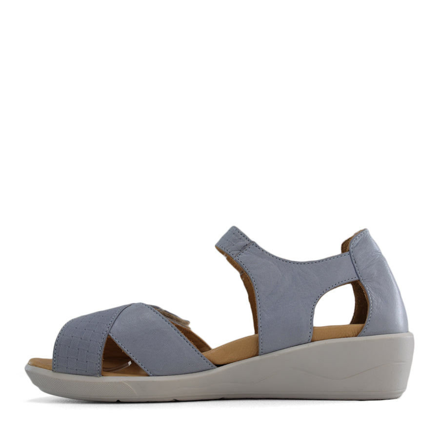SIDE VIEW OF BLUE OPEN TOE SANDAL WITH TWO VELCRO STRAPS AND WHITE SOLE