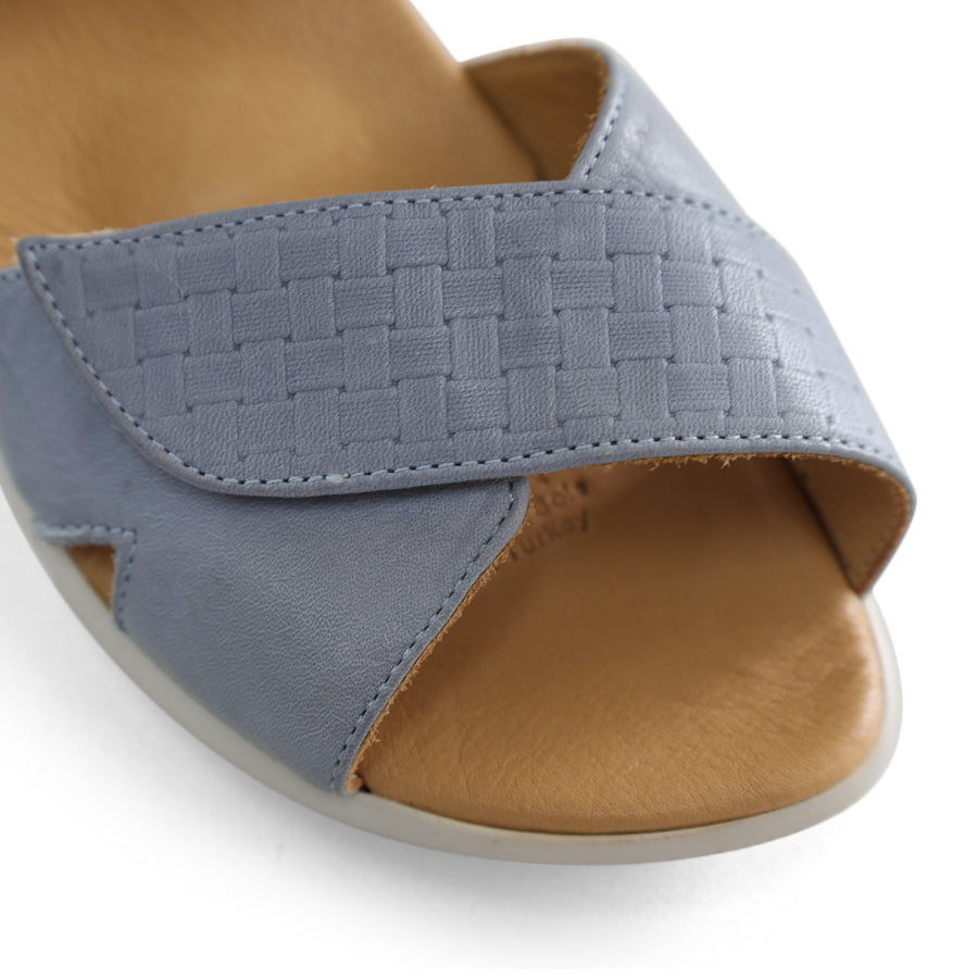 FRONT VIEW OF BLUE OPEN TOE SANDAL WITH TWO VELCRO STRAPS AND WHITE SOLE