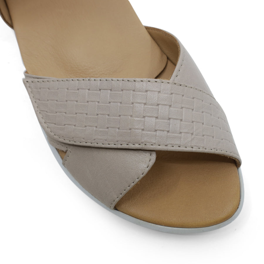 FRONT VIEW OF GREY OPEN TOE SANDAL WITH TWO VELCRO STRAPS AND WHITE SOLE